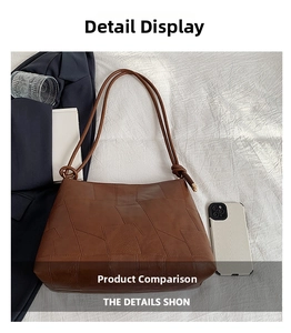 Detail of brown leather tote bag with geometric stitching and gold metal hardware
