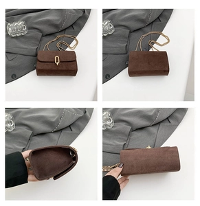 Detail view of brown suede square bag with gold U-lock and elegant chain strap