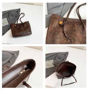 Macro detail of retro brown leather tote bag with woven charm and golden metal zipper