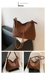 Detail showing brown patchwork leather texture and knot shoulder strap with metal accents