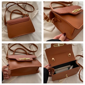 Detail view of vintage brown handbag featuring woven texture and golden twist lock