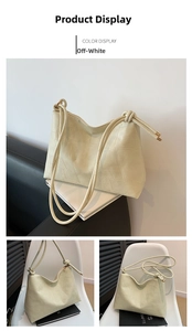 Detail of cream white tote bag featuring geometric stitching and gold zipper closure