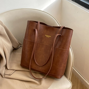 Brown retro leather tote bag with front pockets and elegant long shoulder straps
