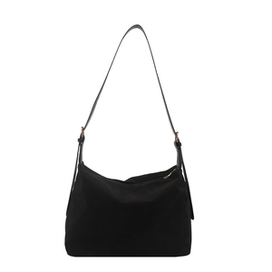 Minimalist black canvas shoulder bag with adjustable strap and gold metal buckle for women