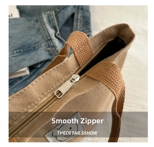 Close-up of smooth metal zipper and thick canvas texture on the bucket bag