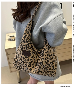 Macro detail of leopard print corduroy texture and fashion leather patch on tote bag
