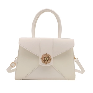 Minimalist cream white leather tote bag with gold petal buckle and adjustable strap