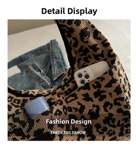 Close-up of leopard print tote interior showing phone and makeup storage space