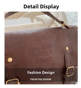 Detail of vintage brown leather backpack with embossed text and rustic brass rivets