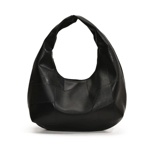 Minimalist black leather patchwork hobo bag with wide shoulder strap for commuting