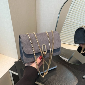 Sac carré minimaliste en daim gris avec bandoulière chaîne dorée et fermoir ovale métal