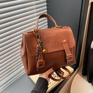 Brown vintage faux leather backpack with letter embossing and textured finish