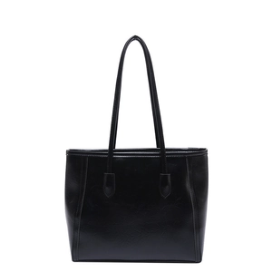 Minimalist black faux leather large tote bag with long shoulder straps on white background