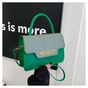 Detail of green leather and herringbone fabric texture with golden metal buckle
