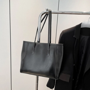 Classic black vintage tote bag with textured leather and slim shoulder straps for daily commute