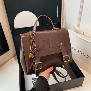 Retro dark brown versatile backpack with gold hardware and artistic embossing