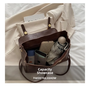 Internal view showing spacious storage for essentials in a vintage brown leather messenger bag