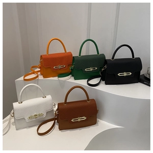 Five textured crossbody bags in various colors displayed on white tiered steps