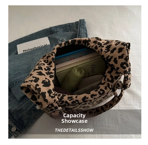 Detailed interior of leopard print corduroy tote bag showing large capacity and daily items