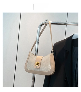 Detail of khaki shoulder bag with glitter texture and gold-tone twist lock closure