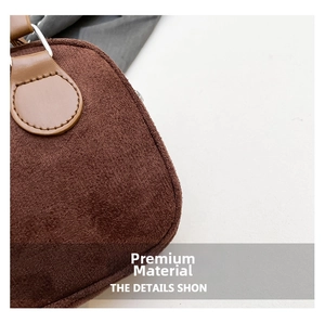 Close-up of brown suede fabric texture and reinforced leather stitching on the pillow bag