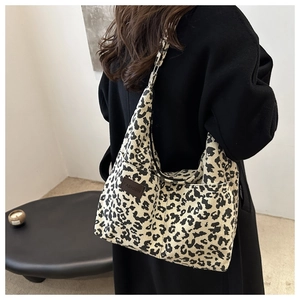 Detail of leopard print corduroy tote bag with Fashion patch on vintage textured fabric