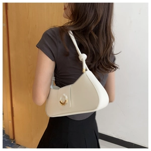 White faux leather underarm bag with knot strap detail and metallic round buckle
