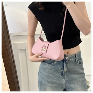 Pink crescent underarm bag styled with casual outfit and metallic ring buckle detail