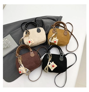 Group of four matte suede Boston bags in white, yellow, coffee, and black with bear charms