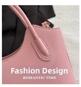 Detail of pink bucket bag featuring leather texture and light gold metal hooks