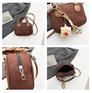 Detail of vintage brown suede bowling bag with silver zipper and plush star charm