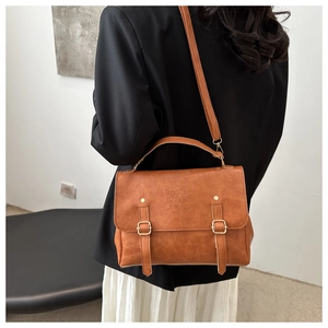 Brown retro leather briefcase bag shown on model for a classic academic style look