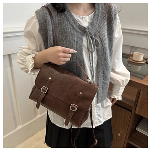 Detailed shot of brown vintage PU leather backpack with double buckle and adjustable strap