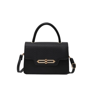 Classic black handbag with woven flap texture and gold metal buckle on white background