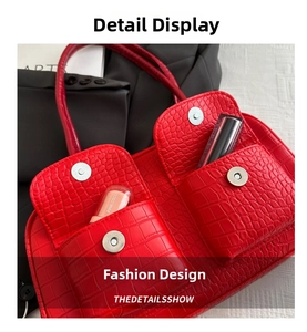 Close-up of red crocodile embossed handbag featuring dual front pockets with magnetic clasps