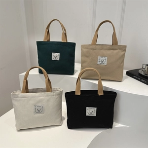 Minimalist canvas tote bags with bear patch in forest green, khaki, cream, and black colors