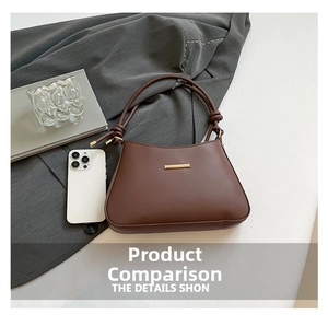 Close-up of brown minimalist shoulder bag with gold metal trim and knotted strap detail