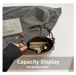 Interior view showing the capacity of this brown half-moon bag for daily essentials