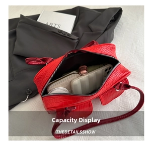 Top view of red crocodile pattern Boston bag showing large interior storage capacity