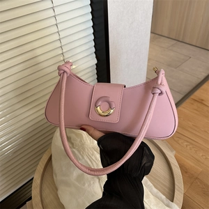 Pink matte leather baguette shoulder bag with gold round buckle and knot strap detail