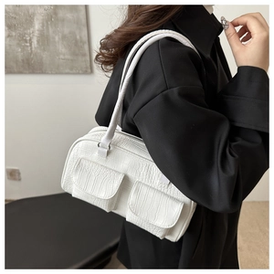 Detailed close-up of white crocodile pattern tote bag with dual front pockets and silver hardware