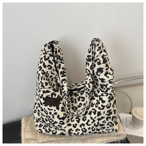 Detail of leopard print corduroy tote bag with leather label on soft fabric base