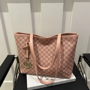 Pink jacquard tote bag with M-pattern lettering and golden metal logo pendant