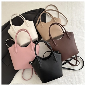 Flat lay of multiple PU leather bucket bags in white, pink, beige, coffee, and black tones