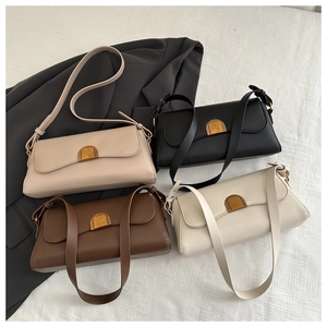 Detail of four retro style baguette bags in black brown beige and cream with gold locks