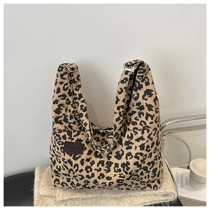 Detail of leopard print corduroy tote with leather fashion patch and adjustable strap