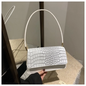 Detail of white crocodile pattern PU leather shoulder bag with gold metal hardware