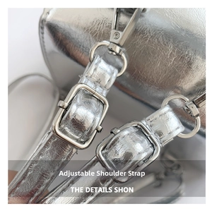 Detail of adjustable silver shoulder strap with metallic buckle on leather crossbody bag