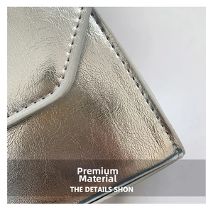 Detailed macro view of silver metallic PU leather texture with fine stitching on a square bag