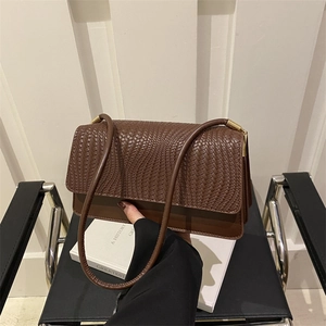 Brown woven leather shoulder bag with gold hardware and rectangular flap structure